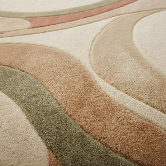 Close up of hand tufted high pile rug showing dense wool fibers, sculpted curves, plush texture, and detailed carving in cream and earthy tones