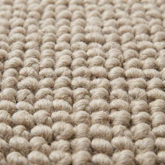 Close-up of oversized pebble loop texture in neutral beige rug