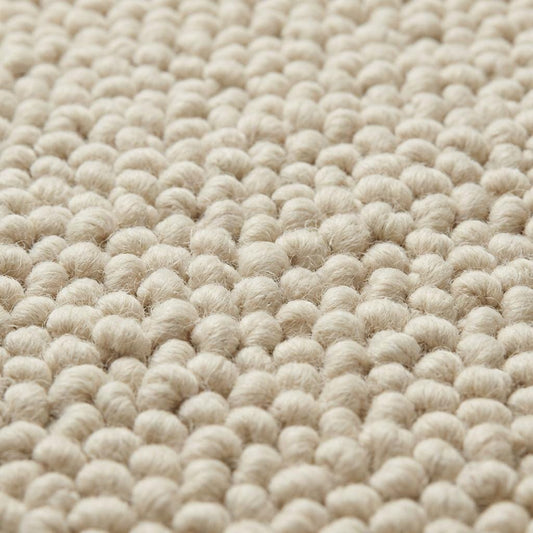 Chunky wool loop rug in cream with oversized textured loops and plush neutral design for cozy hygge decor