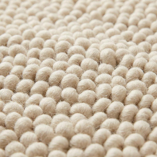 Chunky wool pebble rug in thick ivory with textured loops for cozy modern living rooms