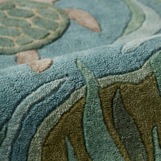 Close-up of tufted sea turtle rug texture showing plush pile, carved pattern detail, soft fiber surface, ocean themed area rug craftsmanship