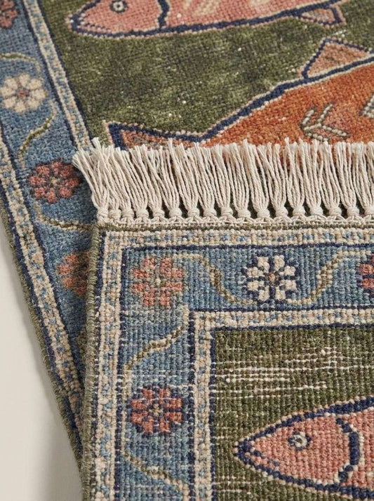 Close-up of hand-knotted wool fibers showing low pile texture, detailed fish motifs, durable knot structure, and artisan craftsmanship. __etsy:8077246172