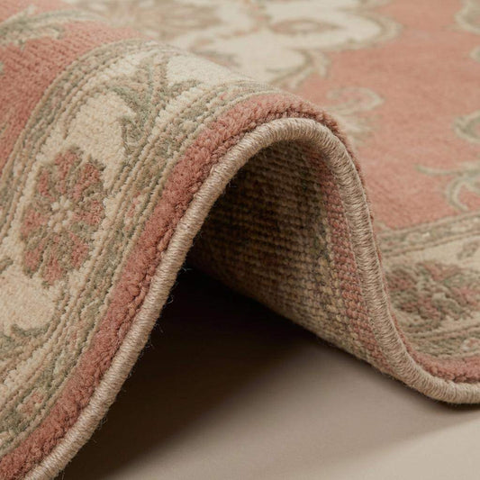 Close up of hand knotted wool rug showing dense knots, natural wool fibers, and detailed craftsmanship