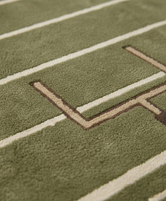 Close-up of plush hand-tufted rug showing dense pile texture, soft fibers, and clean field lines