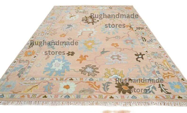 Hand-knotted Oushak wool rug with vintage floral design in light pink and dark brown for living room decor