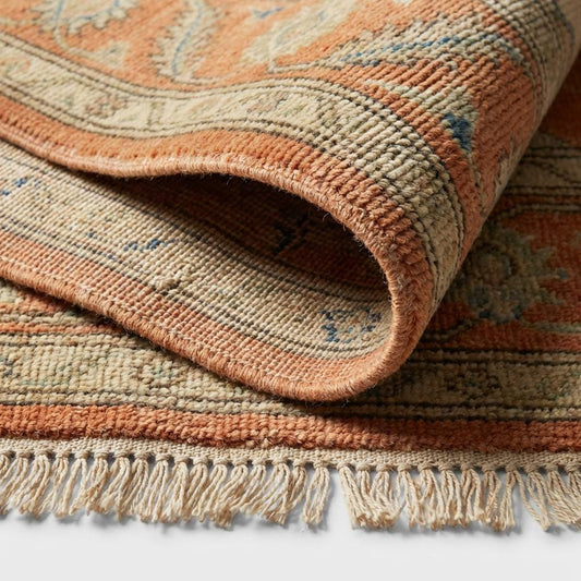 Close-up of the hand-knotted wool pile showing the individual knot structure, natural fiber variations, and soft, dense weave texture.