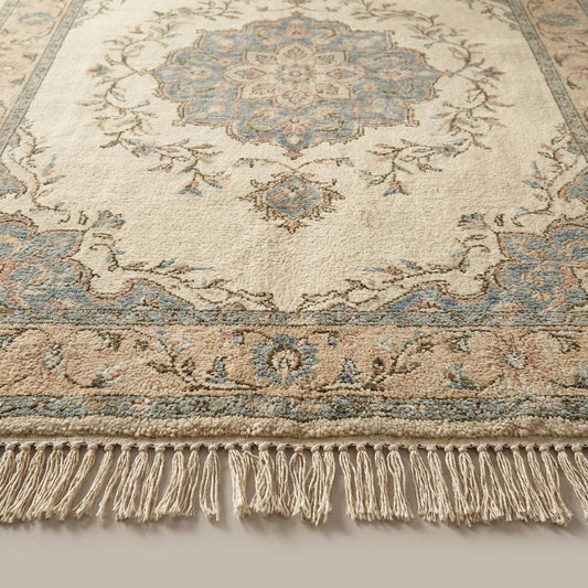 Close-up of hand knotted wool rug showing dense knots, natural wool fibers, and cotton foundation