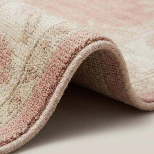Hand knotted Oushak rug in blush pink with floral medallion, wool area rug for living room and bedroom