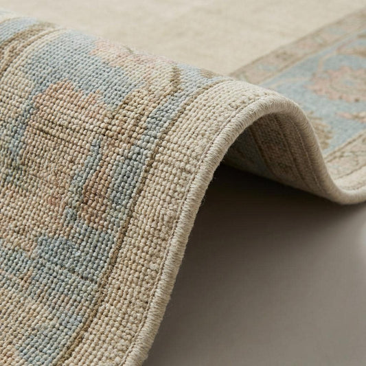 Close-up of dense hand-knotted wool pile showing individual knots, soft natural fibers, and subtle tonal variation