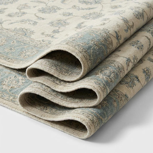 Close-up of hand knotted wool pile showing individual knots, natural fiber texture, and soft matte finish