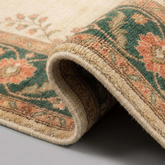 Close up of hand knotted wool pile showing individual knots, soft texture, and vegetal dye color variations.