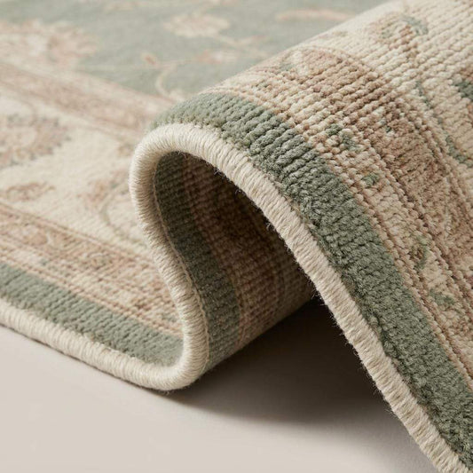 Close-up texture of hand knotted wool rug showing dense knot structure, soft pile, floral motifs, and artisan weave detail __etsy:7957582398