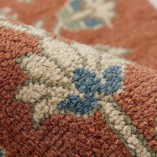 Close-up of hand knotted wool pile showing dense knots, natural fiber texture, and artisanal craftsmanship