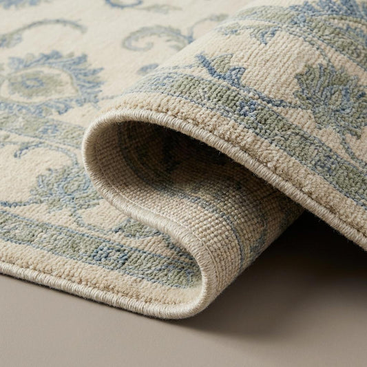 Close up of hand knotted wool rug showing individual knots, natural wool fibers, and soft pile texture