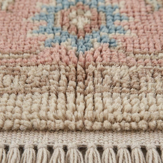 Close-up of hand knotted wool pile showing individual knots, soft wool fibers, and artisanal texture