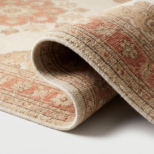 Hand knotted Oushak wool rug with ivory and terracotta floral medallion in vintage style living room setting