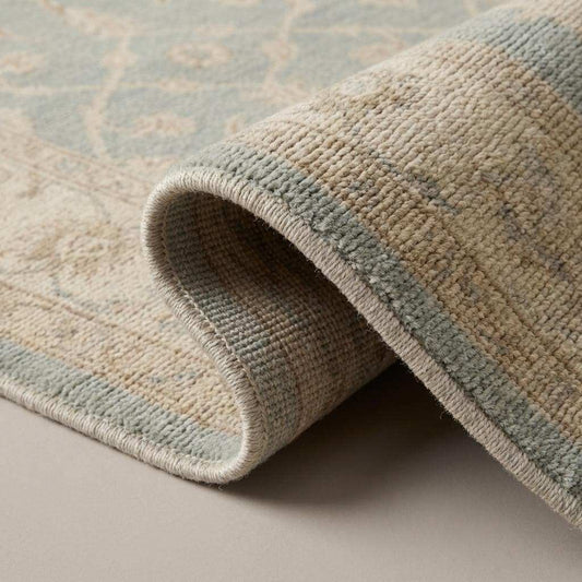 Hand knotted Oushak wool rug in light blue and beige with vintage floral design and neutral Turkish style for living room