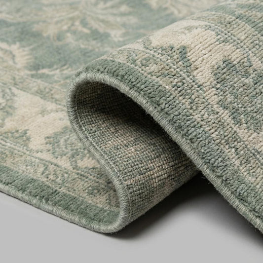 Hand knotted Oushak wool rug with sage green vintage floral design in traditional Persian style