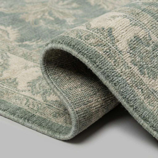 Hand knotted Oushak wool rug with sage green vintage floral design in traditional Persian style