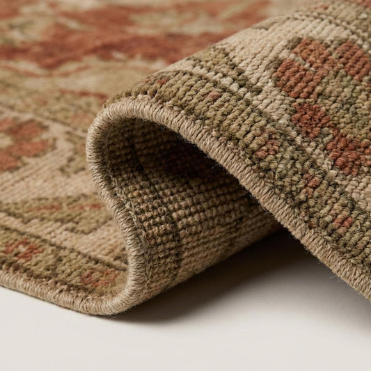 Close-up of hand knotted wool pile showing natural texture, low pile height, and subtle abrash