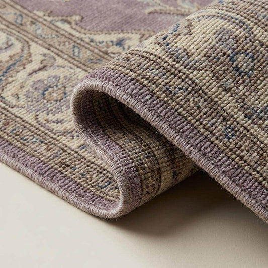 Close-up of hand knotted wool rug showing dense knot structure, natural wool fibers, and detailed craftsmanship