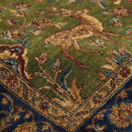 Hand knotted Persian style green wool area rug with deer and floral border design