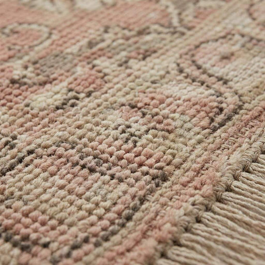 Close up of hand-knotted wool pile showing individual knots and soft texture, distinguishing it from machine-made or tufted rugs.