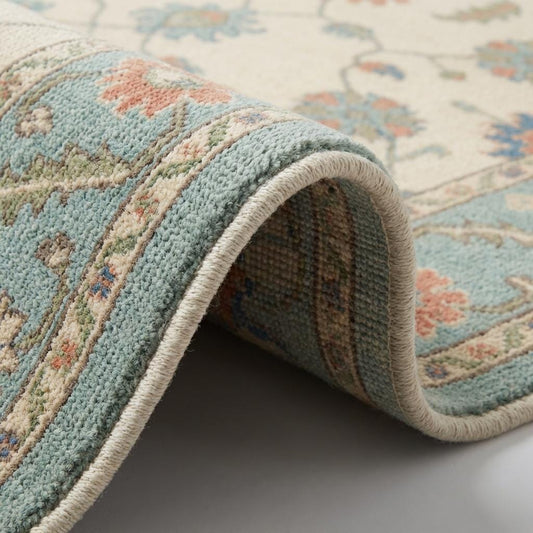 Hand knotted wool Oushak rug with blue floral Persian design and cream teal tones