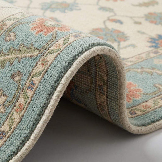Hand knotted wool Oushak rug with blue floral Persian design and cream teal tones