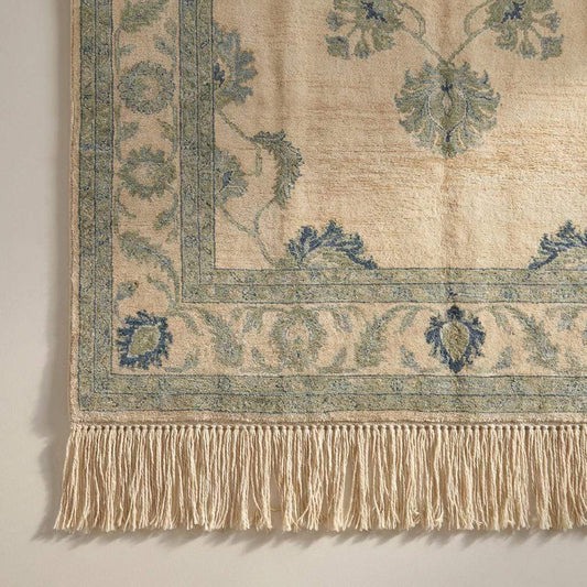 Close up detail showing the dense wool pile and individual knot structure of the artisan handmade rug construction.