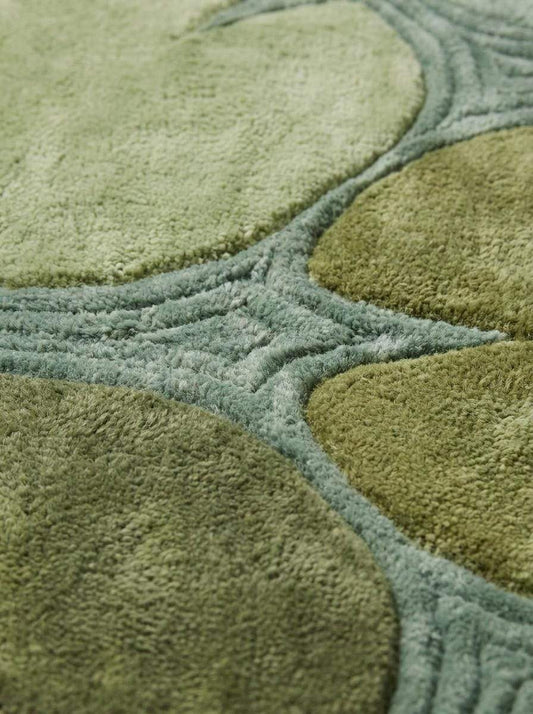 Hand tufted lily pad runner rug in shades of green with organic botanical design for hallway decor