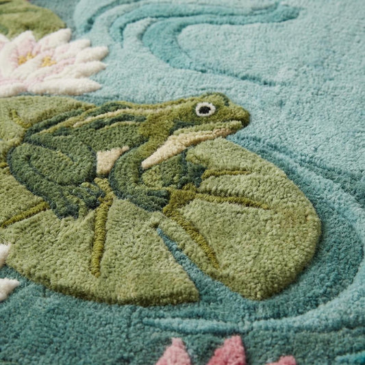 Hand tufted wool area rug with lily pond frog design in aqua blue and green tones for nursery or cottagecore decor