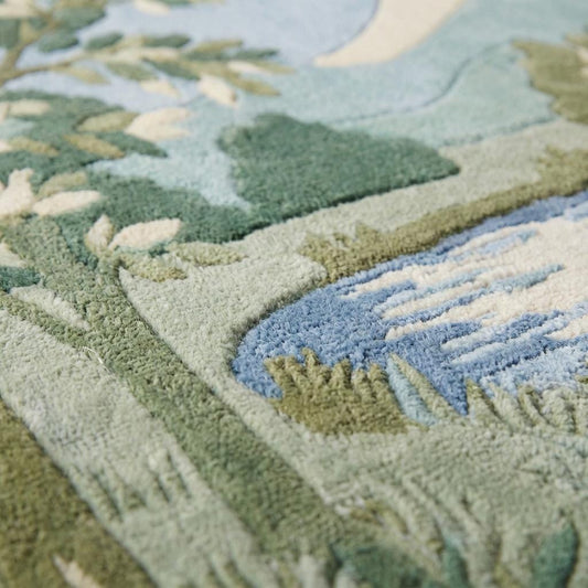 Hand tufted wool landscape rug with carved high-low pile and green botanical design in living room