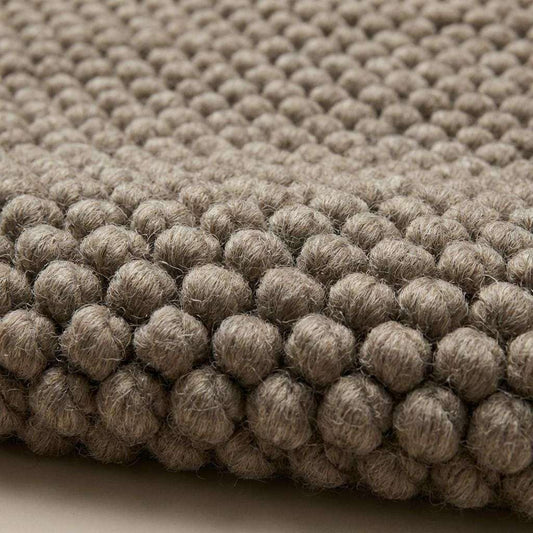 Neutral handmade chunky knit wool rug with thick texture for cozy interiors
