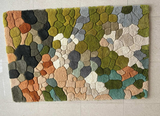 Handmade wool tufted moss rug with nature-inspired forest floor design, soft and cozy texture, rectangular shape, perfect for living room and kids play room decor.