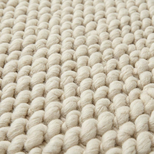 Handwoven chunky wool rug with thick braided texture in neutral tones for Scandinavian décor