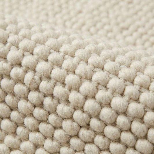 Handwoven chunky cream wool rug with thick knit texture for cozy Scandinavian decor