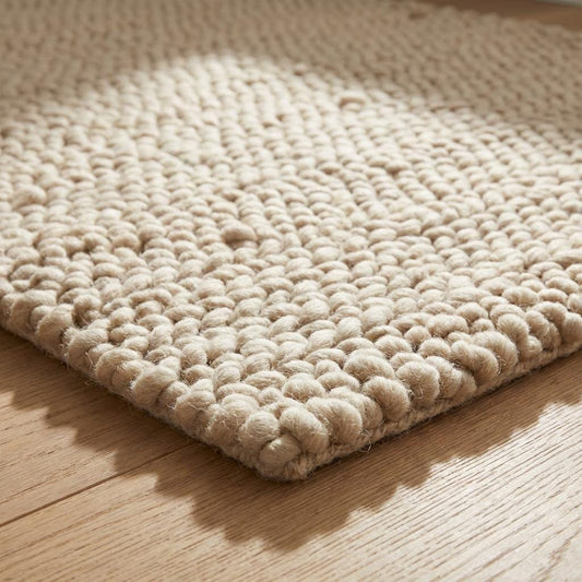 Neutral wool area rug with chunky loops, cozy Scandinavian rug for living room or bedroom décor