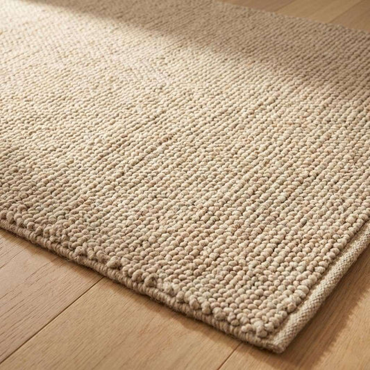 Handwoven chunky wool rug with thick looped weave in neutral beige farmhouse style
