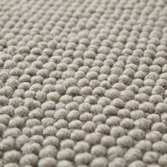 Handwoven chunky wool rug in neutral gray with thick texture for Scandinavian farmhouse decor