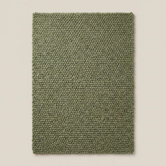 Handwoven chunky wool rug in sage green with thick textured weave for Scandinavian decor