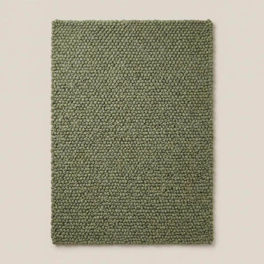 Handwoven chunky wool rug in sage green with thick textured weave for Scandinavian decor