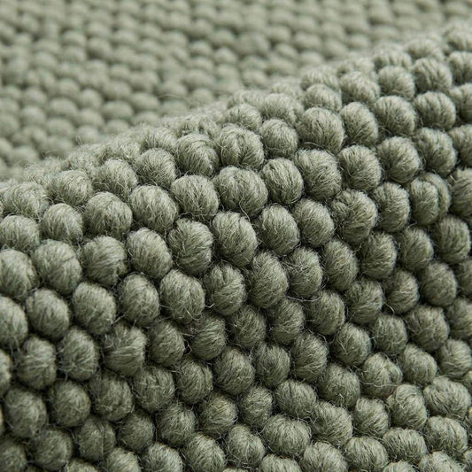Handwoven chunky wool rug with thick texture in neutral tones for Scandinavian home decor