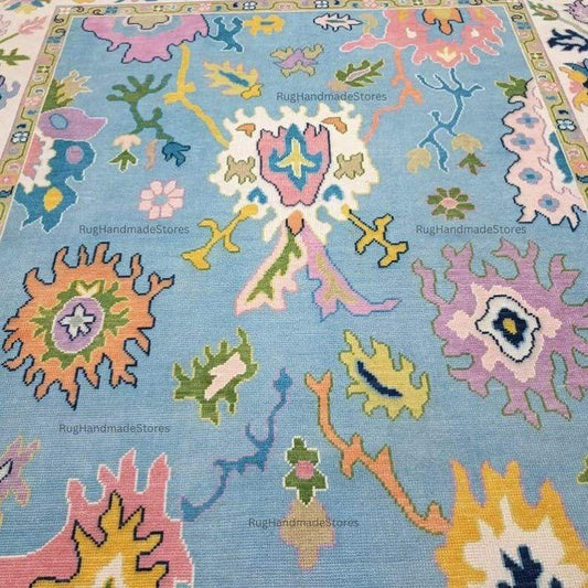 Handwoven Oushak rug with sky blue, aqua, and mustard floral pattern, handmade Turkish boho carpet