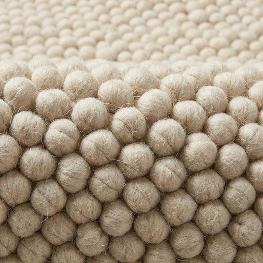 Ivory chunky wool rug with thick looped texture for cozy modern minimalist interiors