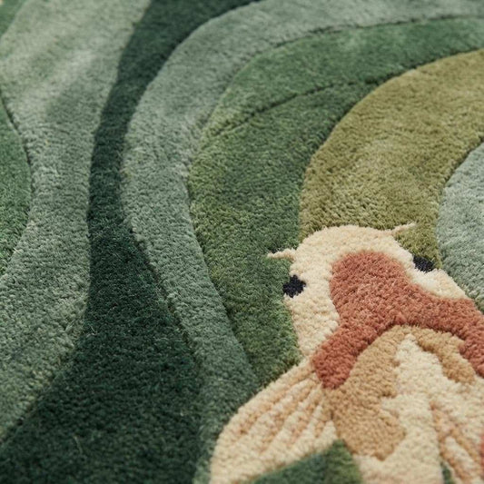 Close-up of hand-tufted koi fish rug showing plush fibers, carved texture, raised koi details, and high-quality craftsmanship with soft green and cream tones.