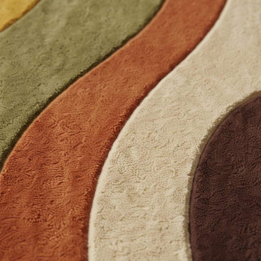 Earth tone abstract area rug with curved wavy shapes in mustard, olive and rust, styled in a sunny mid century living room with wood parquet floor and yellow chair.