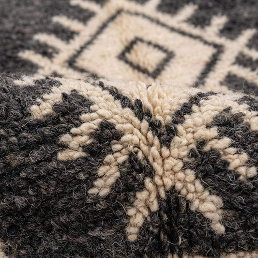 Charcoal and ivory Moroccan geometric rug with tribal diamond pattern for boho living room decor
