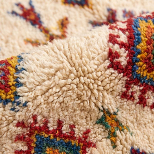Ivory Moroccan geometric rug with colorful Berber diamond pattern and fringe for boho living room decor