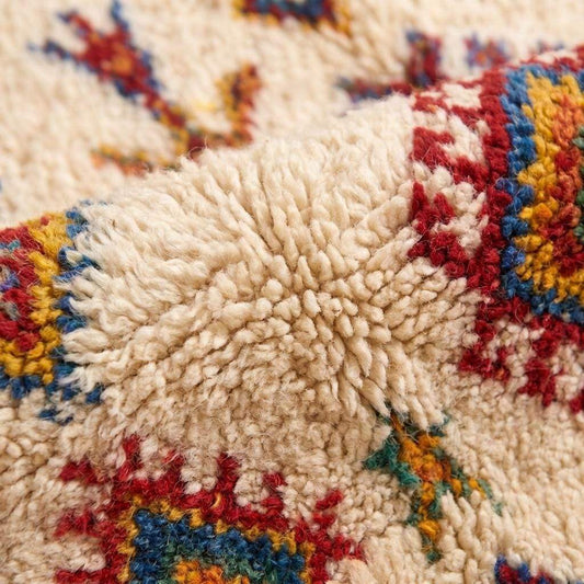 Ivory Moroccan geometric rug with colorful Berber diamond pattern and fringe for boho living room decor